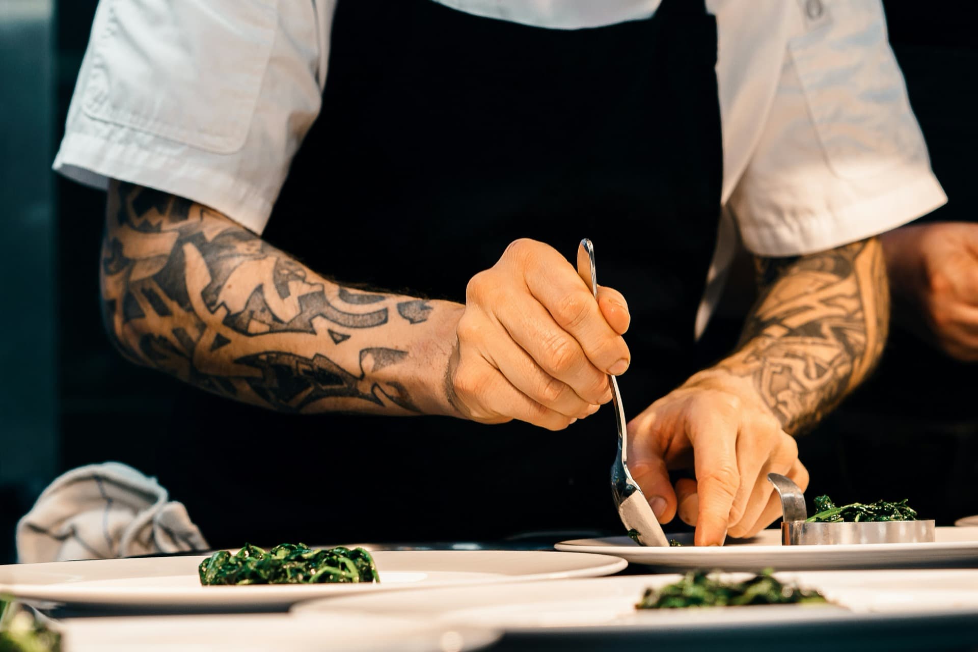 Personal chef plating a dish for a private dinner event